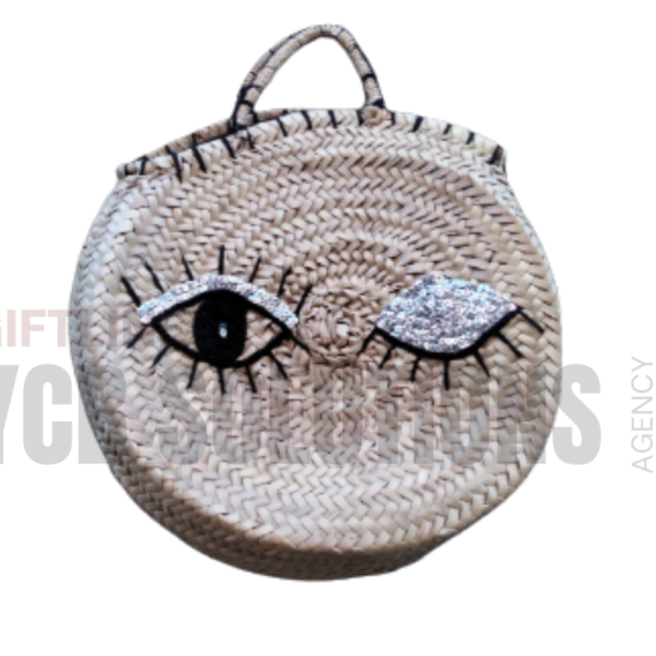 Panier rond en paille tressée motif œil scintillant